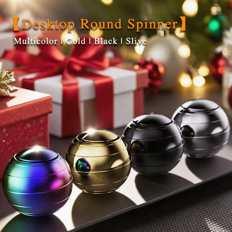 A set of multicolor, gold, black, and silver metal fidget spinners displayed on a dark surface with wrapped gifts in the back