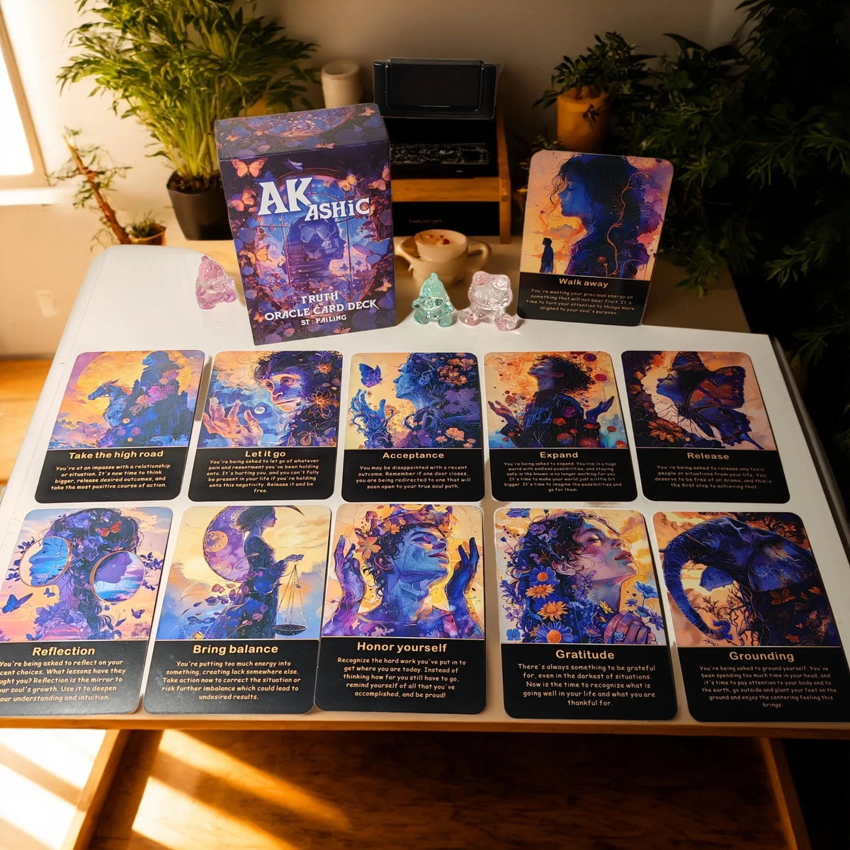 A box of Akashic Oracle Cards featuring various colored cards for energy healing and soul purpose.