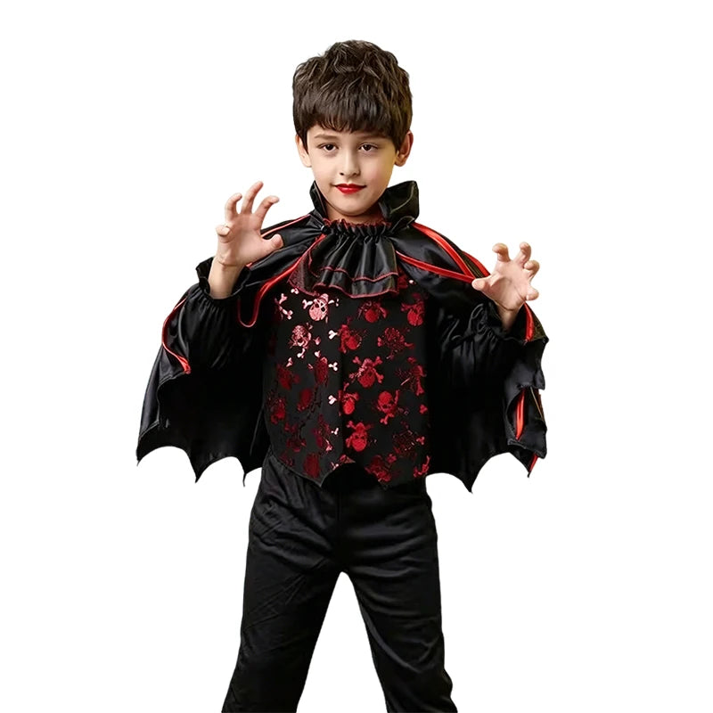 A young boy wearing a black vampire bat costume set with a cape and accessories.