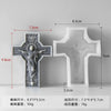 A white silicone mold shaped like a cross with a figure, shown next to its corresponding resin or soap casting.