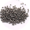 A pile of small, silver metallic glass beads for jewelry making.