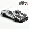 A white and black diecast model of a Toyota AE86 sports car with racing decals.
