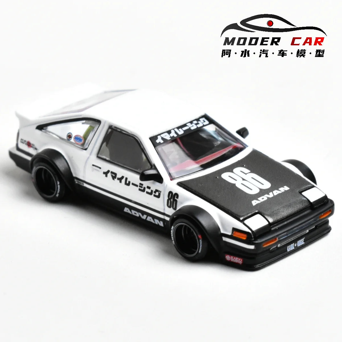 A white and black diecast model of a Toyota AE86 sports car with racing decals.