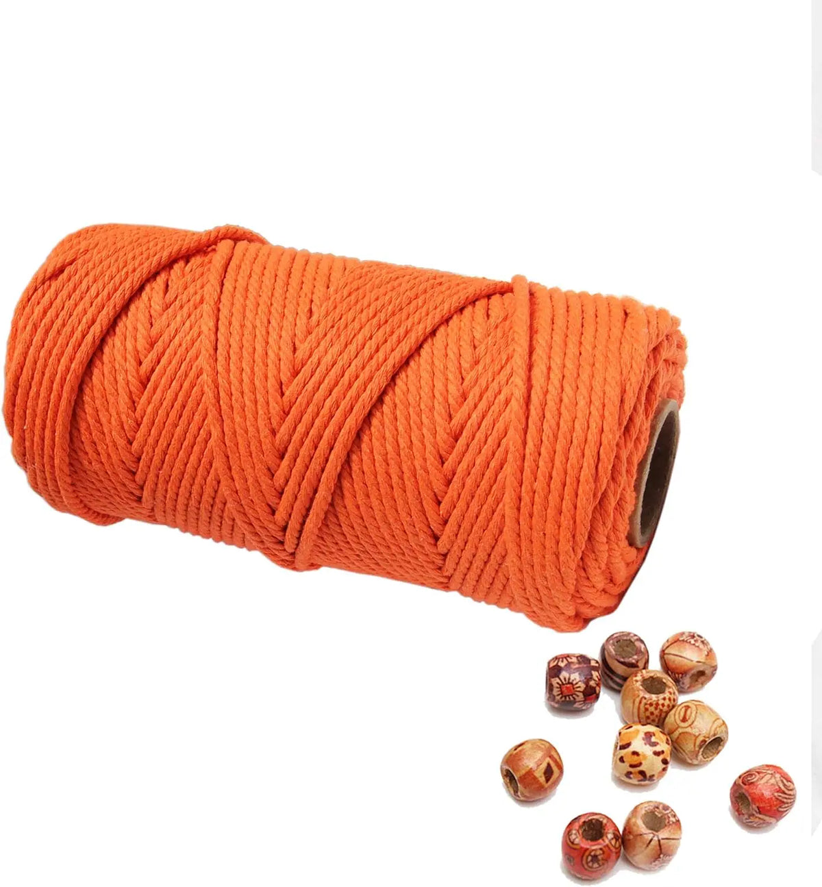 A spool of bright orange natural cotton macrame rope for crafts and decor.