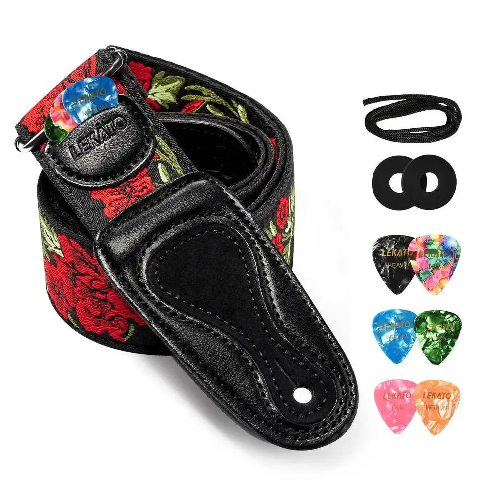 Black guitar strap with floral pattern, featuring picks and strap locks.