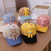 A collection of five toddler bear baseball caps in various colors and designs resting on a wooden table.