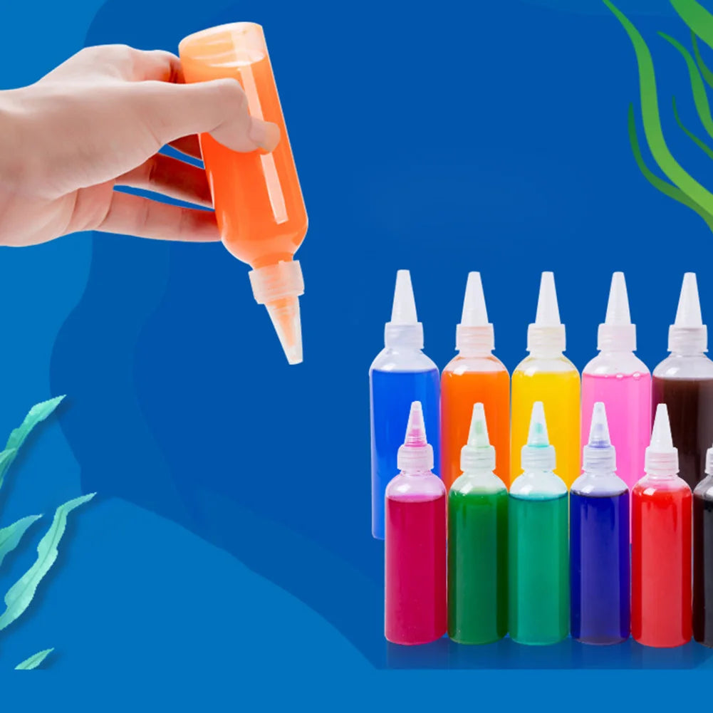 A hand is squeezing orange liquid from a bottle, next to various colorful gel molds and liquids.