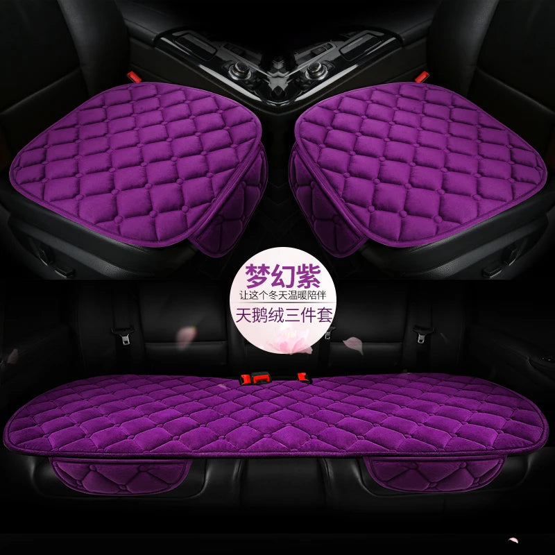 A set of three purple quilted plush anti-slip car seat cushions shown in the interior of a car.
