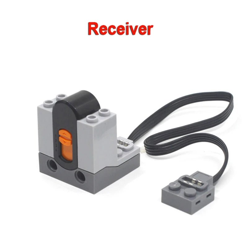 A gray receiver unit with a black connector and attached wire, used for technical power functions motor set.