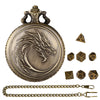 A brass steampunk dragon pocket watch dice case with a chain and seven small dice.