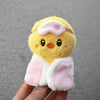 A yellow cartoon animal plush toy with pink accents and a light pink bag charm attached.
