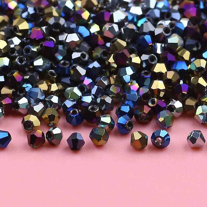 A pile of iridescent, faceted crystal glass beads in various shades of blue, purple, and gold.