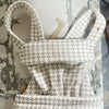 A white and gray patterned adjustable cotton baby carrier wrap displayed on a marble surface.