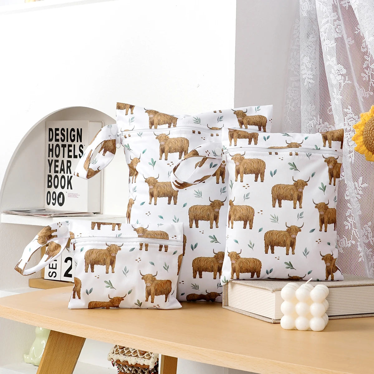 A pack of three waterproof wet and dry bags featuring a repeating pattern of brown sheep for travel and storage.
