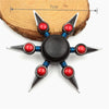 A metal fidget spinner with a rainbow finish, featuring black and silver components.