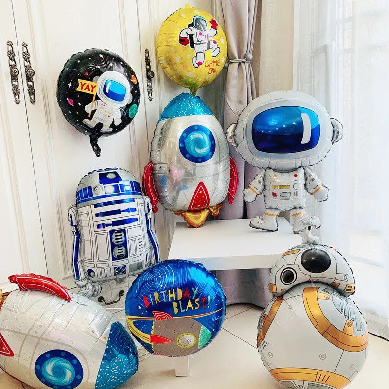 A collection of outer space astronaut themed party decor including balloons and a figure