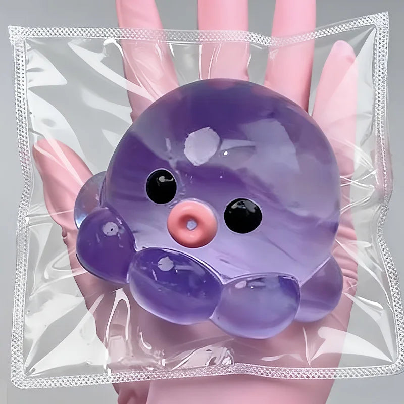 A purple squishy bubble squid stress relief toy is held in a person's hand inside a clear plastic bag.