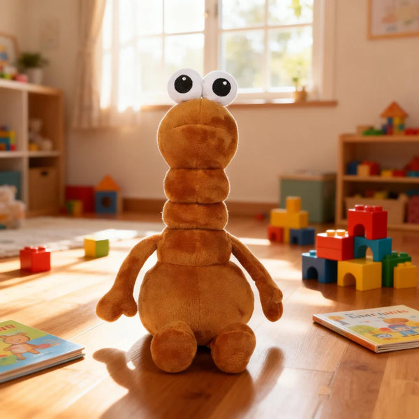 A fluffy brown plush toy with large eyes sits on a wooden floor near a window and colorful toys.