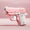 A pink stress relief fidget pistol toy with a burst slide action visible in a studio setting.