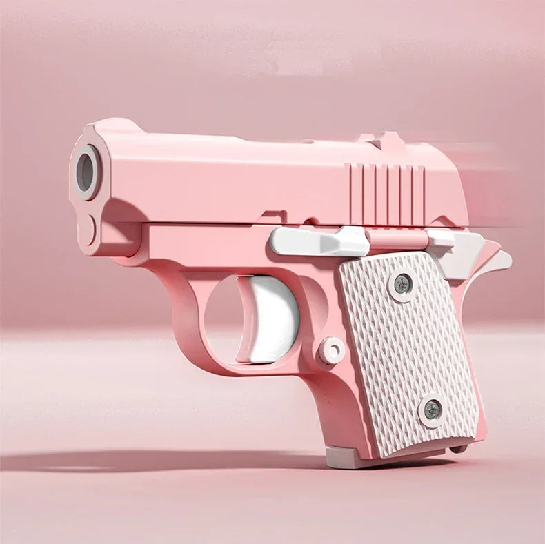 A pink stress relief fidget pistol toy with a burst slide action visible in a studio setting.