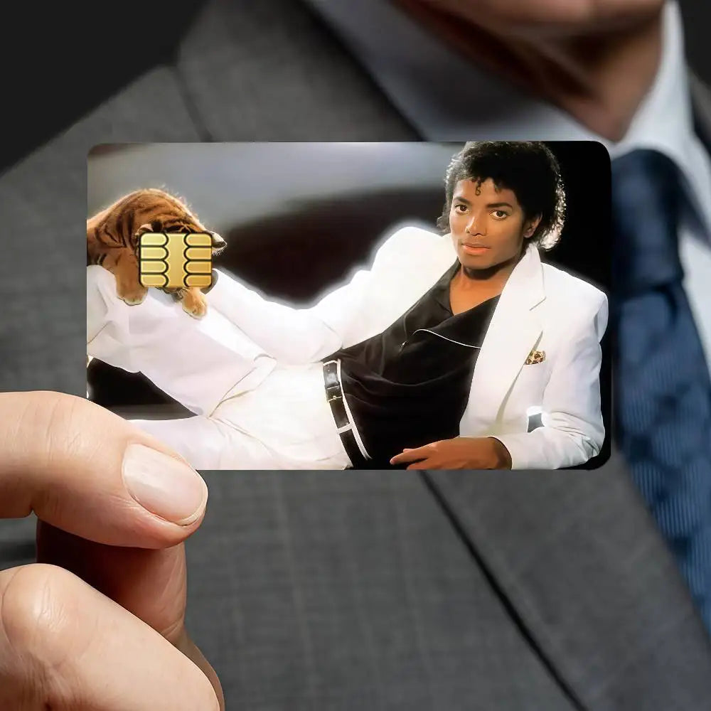 A close-up photo of a person holding a credit card decorative sticker set featuring a portrait of Michael Jackson.