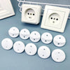 A white pack of six rotating socket safety covers for baby proofing displayed next to electrical outlets.