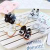 A collection of casual sneakers for 17cm Labubu dolls in various colors and patterns arranged on a wooden surface.