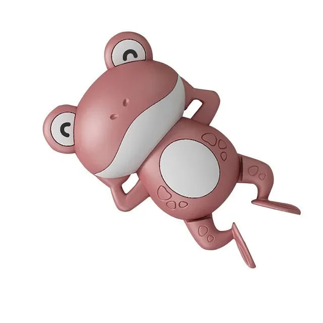 A pink wind-up swimming turtle bath toy with white markings.