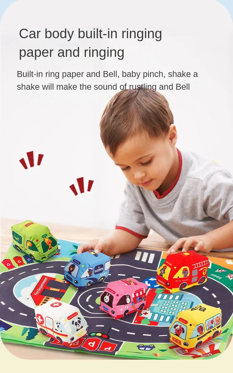 A child plays with a set of car toys, including a fabric car, map game mat, and storage bag.