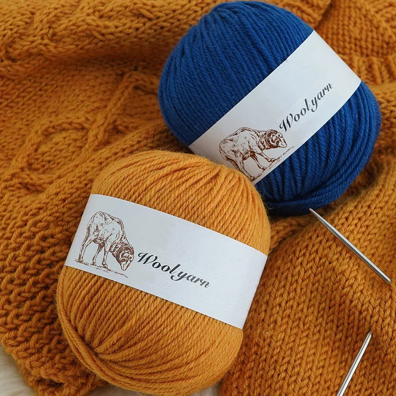 A blue and orange ball of wool yarn with labels showing Woolyarn for knitting.