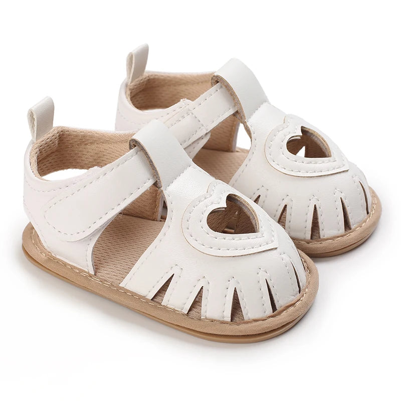 Pair of white breathable baby first walker sandals with soft anti-slip soles