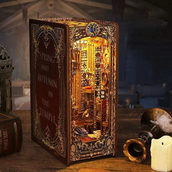 A detailed miniature dollhouse kit featuring ornate furniture and decorative elements displayed in a wooden box.