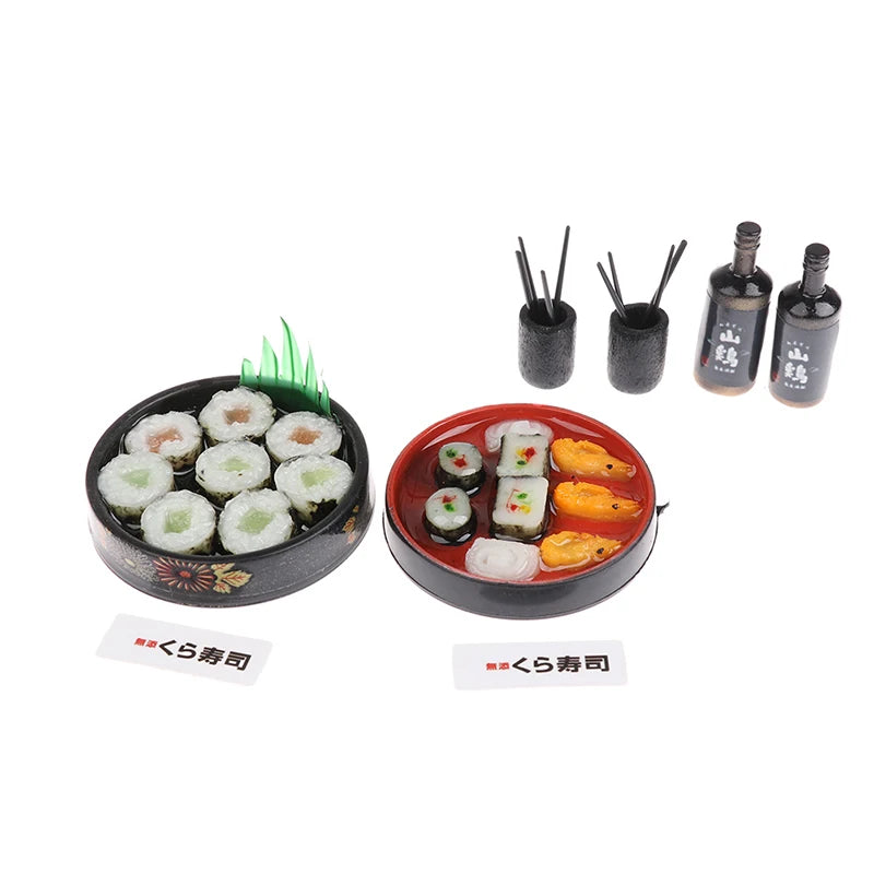 A set of miniature Japanese sushi, including various rolls and nori, displayed on a black plate.