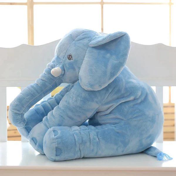 A soft blue plush elephant doll cushion sitting on a white surface.