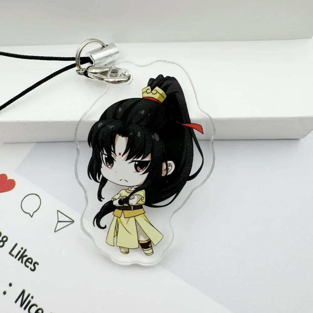 A clear acrylic pendant featuring an anime character with black hair and yellow clothing attached to a black cord and metal k
