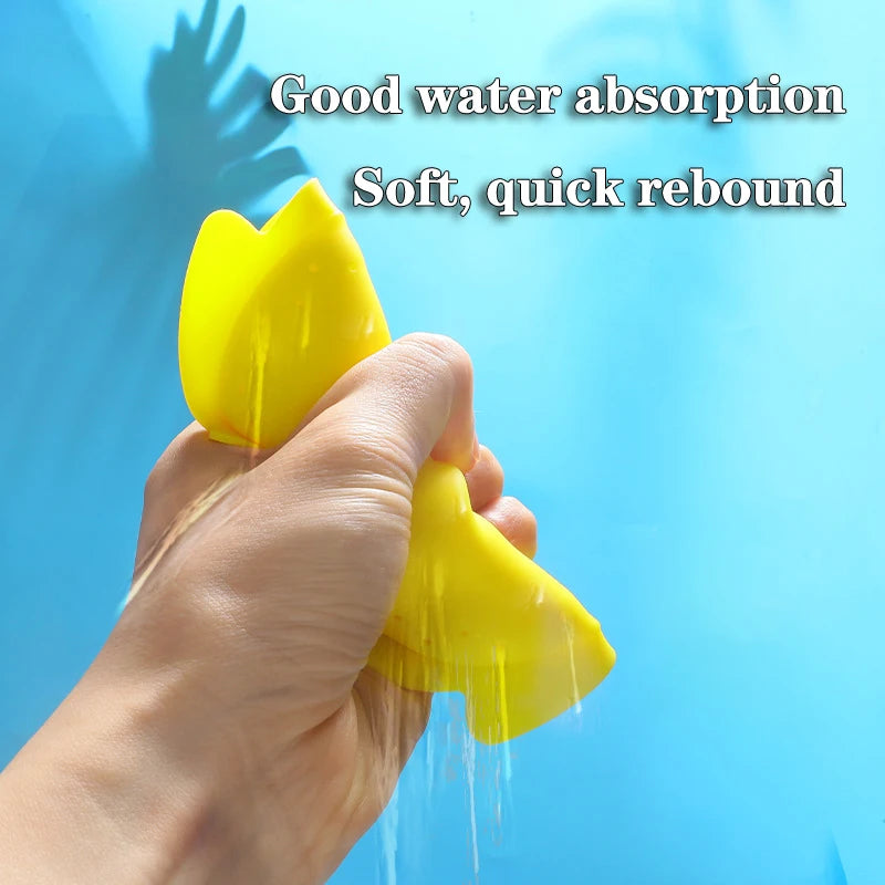A hand is holding a yellow silicone splash flying ring, demonstrating its water absorption and soft rebound properties.