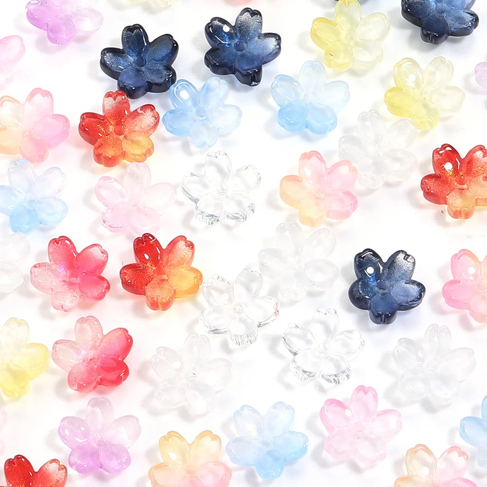 A collection of colorful cherry blossom flower glass beads in various shades of pink, blue, yellow, and orange.