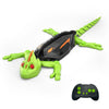 A green wall-climbing RC gecko toy with glowing eyes is shown against a white background.