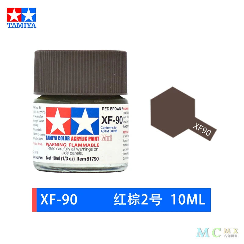 A bottle of red acrylic paint labeled XF-90 with a dark cap and a warning label.
