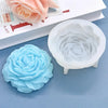 A silicone mold shaped like a peony flower is shown next to its white baking tray.