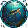 A wooden 3D puzzle of a sea turtle swimming in an underwater coral reef scene.