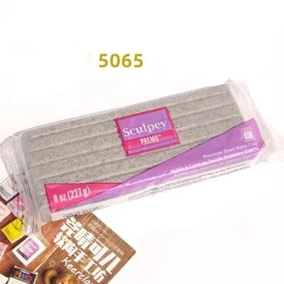 A block of gray polymer clay labeled Sculpey PREMO is shown in packaging.