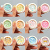 A set of iridescent opal and mermaid chrome nail glitter pigments shown on fingernails.