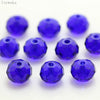 A collection of round, deep blue crystal glass beads used for jewelry making.