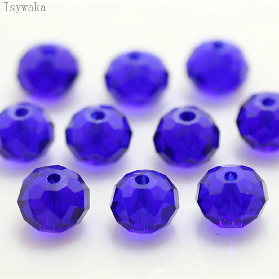 A collection of round, deep blue crystal glass beads used for jewelry making.