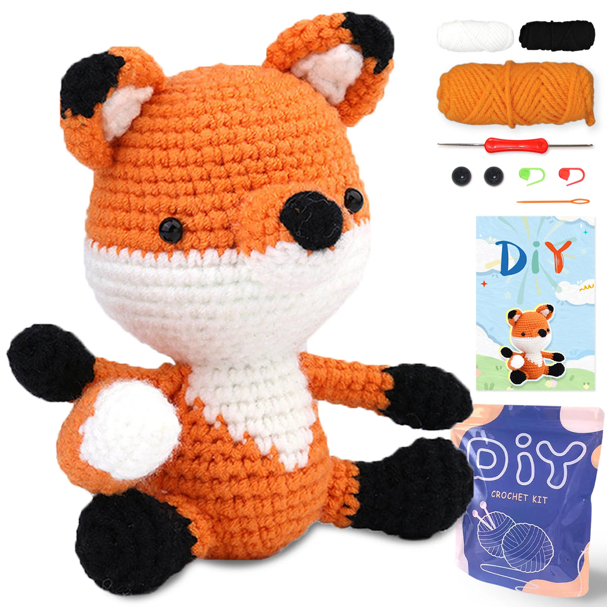 A crocheted fox toy kit showing the finished orange and white fox figure along with yarn and tools.