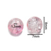 A round, pink glass crackle bead with a 1.3mm diameter and an 8mm thickness.