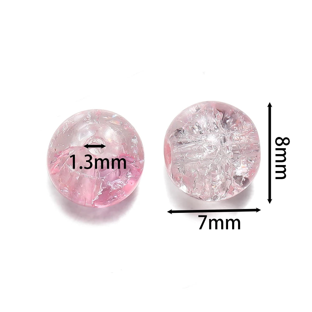 A round, pink glass crackle bead with a 1.3mm diameter and an 8mm thickness.