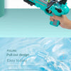 A hand holds a teal airplane launcher toy with foam planes, demonstrating its pull-out design.
