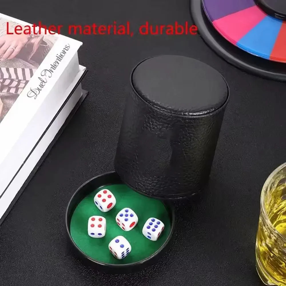 A black leather dice cup with a green lining and five white dice is shown on a dark surface.